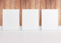 Triple 8x10 Vertical White Frame mockup on white floor and rustic wooden wall Royalty Free Stock Photo