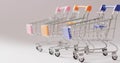 Three empty shopping trollies on seamless grey background