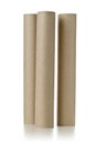 Three empty, used, brown cardboard roll tubes over white