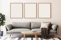 Three empty vertical picture frames in a modern japandi living room with grey sofa and minimalist table. Wall art mockup