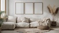 Three empty vertical picture frames in a modern living room with white sofa and boho decor. Wall art mockup. Royalty Free Stock Photo