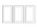 Three empty white picture frames on a wall Royalty Free Stock Photo