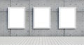 Three blank white frames on a textured concrete wall with tiled floor Royalty Free Stock Photo