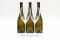 Three empty wine bottles and two glasses on a white background Royalty Free Stock Photo