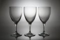 Three empty wine glasses isolated on light background. Minimalist glassware set for restaurant, bar, wine tasting Royalty Free Stock Photo