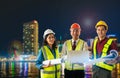 Three engineer male female with blueprint and computer on bright Modern night Japan city with Furturistic light