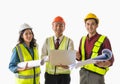 Three engineer male female team is holding plan and computer isolated on white