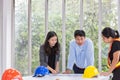 Three engineers working meeting room at the office. Three workers are talking construction plan. Electricians carpenter or Royalty Free Stock Photo