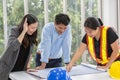 Three engineers working meeting room at the office. Three workers are talking construction plan. Electricians carpenter or Royalty Free Stock Photo