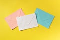 Three envelopes of different colours, shot from above