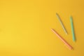 Three erasable pens on yellow background, flat lay. Space for text