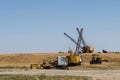 Three excavators dragline one bulldozer and one dismantled excavator