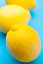 Three exotic yellow lemon on a blue background