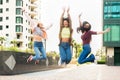 Three exuberant young woman leaping into the air together