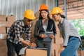 three factory employees deliberate while checking goods in the warehouse Royalty Free Stock Photo