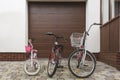 Three family bikes stand in front of the house.