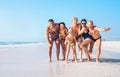 Three family generations on the one long shoot posing for group photo on the beach. Kids, teenagers, Parents and Grandparents