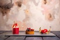 Three fancy desserts with berries on a gray slate board against a mottled pink background Royalty Free Stock Photo