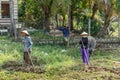 Three Farmers with hoe take a rest in Nha Trang, Vietnam