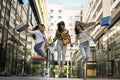 Three fashionable young women strolling with shopping bags. Royalty Free Stock Photo