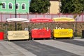 Three fast food stalls on wheels. Kiosks selling drinks, ice cream, sweet corn and hot dogs.