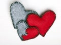 Three felt hearts on a white wooden background Royalty Free Stock Photo