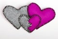 Three felt hearts on a white wooden background Royalty Free Stock Photo