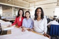 Three female architects working together look to camera Royalty Free Stock Photo