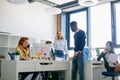 Three female colleagues are sharing with good business news on their cellphones Royalty Free Stock Photo