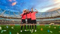 Three female soccer players celebrating victory on soccer filed Royalty Free Stock Photo