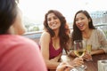 Three Female Friends Enjoying Drink At Outdoor Rooftop Bar Royalty Free Stock Photo