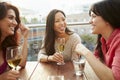 Three Female Friends Enjoying Drink At Outdoor Rooftop Bar Royalty Free Stock Photo