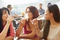 Three Female Friends Enjoying Drink At Outdoor Rooftop Bar Royalty Free Stock Photo