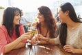 Three Female Friends Enjoying Drink At Outdoor Rooftop Bar Royalty Free Stock Photo