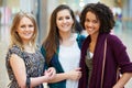 Three Female Friends Shopping In Mall Together Royalty Free Stock Photo