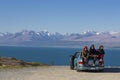 Three Female Friends Sitting In Trunk Of Car On Road Trip