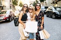 Three female friends walk after shopping Royalty Free Stock Photo