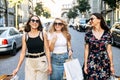 Three female friends walk after shopping Royalty Free Stock Photo