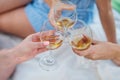 Three female hands with glasses of white wine. Toast, congratulations on an outdoor picnic. The concept of relaxation Royalty Free Stock Photo