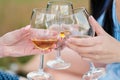 Three female hands with glasses of white wine. Toast, congratulations on an outdoor picnic. The concept of relaxation Royalty Free Stock Photo