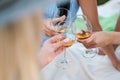 Three female hands with glasses of white wine. Toast, congratulations on an outdoor picnic. The concept of relaxation Royalty Free Stock Photo