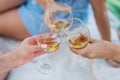 Three female hands with glasses of white wine. Toast, congratulations on an outdoor picnic. The concept of relaxation Royalty Free Stock Photo