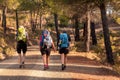 Three female pilgrims with backpacks on a path of crushed stones on the Via de la Plata to Santiago de Compostela Royalty Free Stock Photo