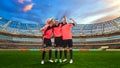 Three female soccer players celebrating victory on soccer filed Royalty Free Stock Photo