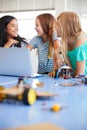Three Female Students Building And Programing Robot Vehicle In After School Computer Coding Class Royalty Free Stock Photo