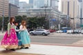 Three female tourist walking outside Gyeongbokgung palace wearing Korean traditi
