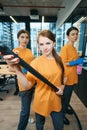 Three female workers cleaning company in protective gloves cleaning office space Royalty Free Stock Photo