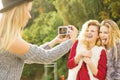 Fun woman taking pictures of females Royalty Free Stock Photo