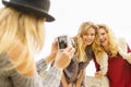 Fun woman taking pictures of females Royalty Free Stock Photo