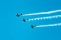 Three fighter jets flying in formation at an airshow